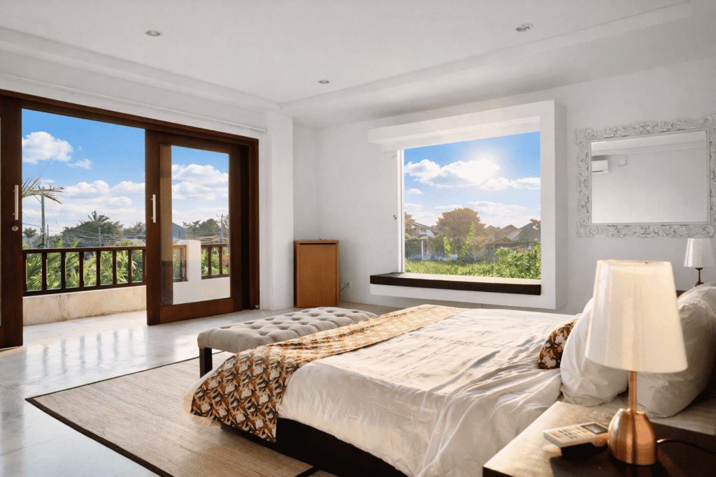 bright and airy bedroom with balcony view.png